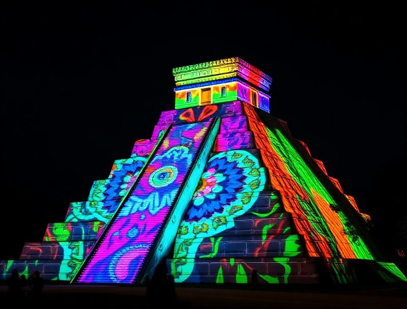 Colorful light projections on El Castillo at night