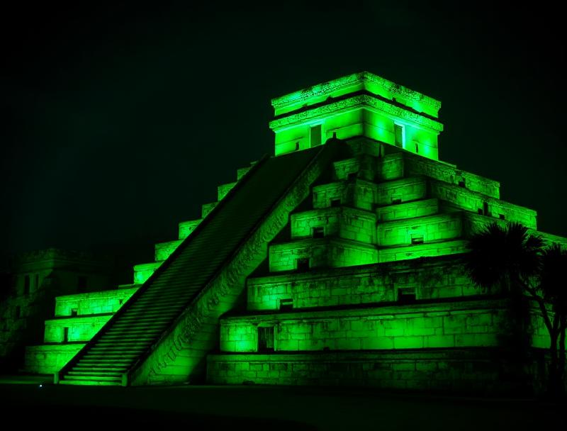 Starry night sky above illuminated Chichen Itza